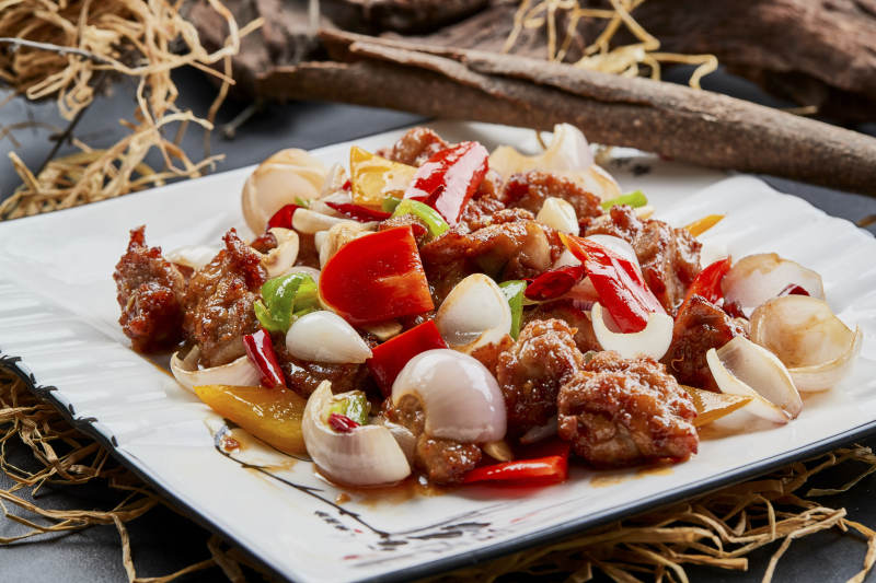 白色瓷盘装的彩椒洋葱猪小排