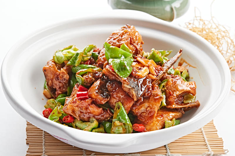 白色砂锅装的砂锅酱爆大鱼头