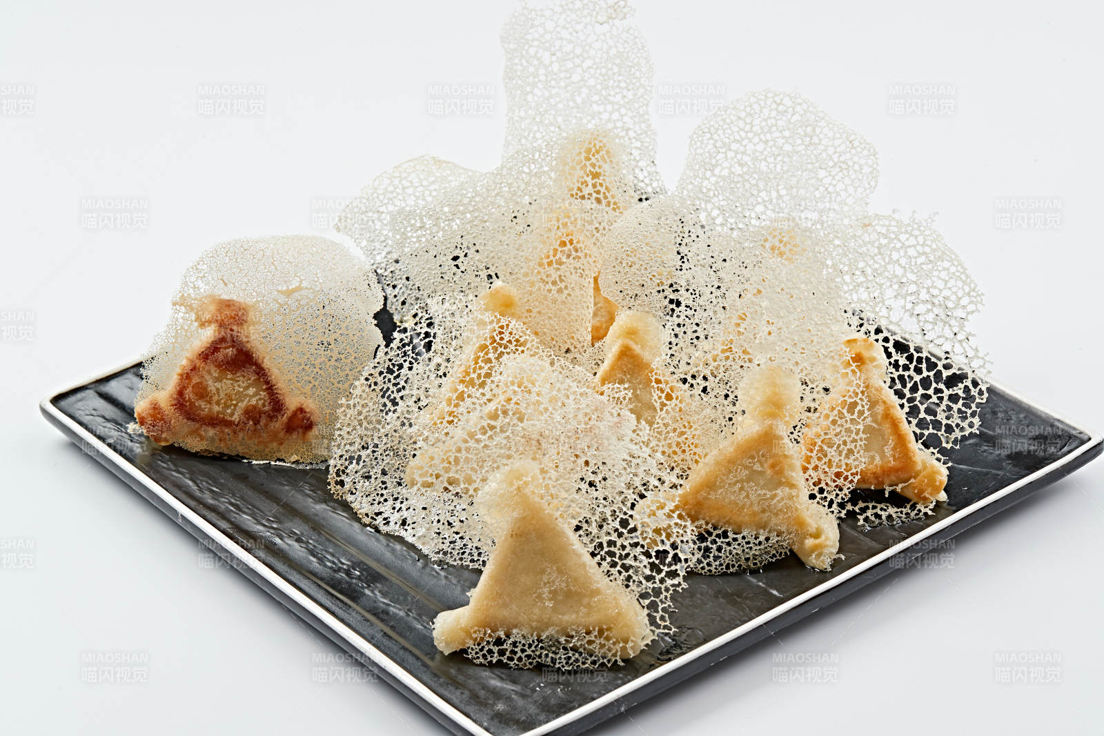 黑色瓷盤裝的漁網水煎包