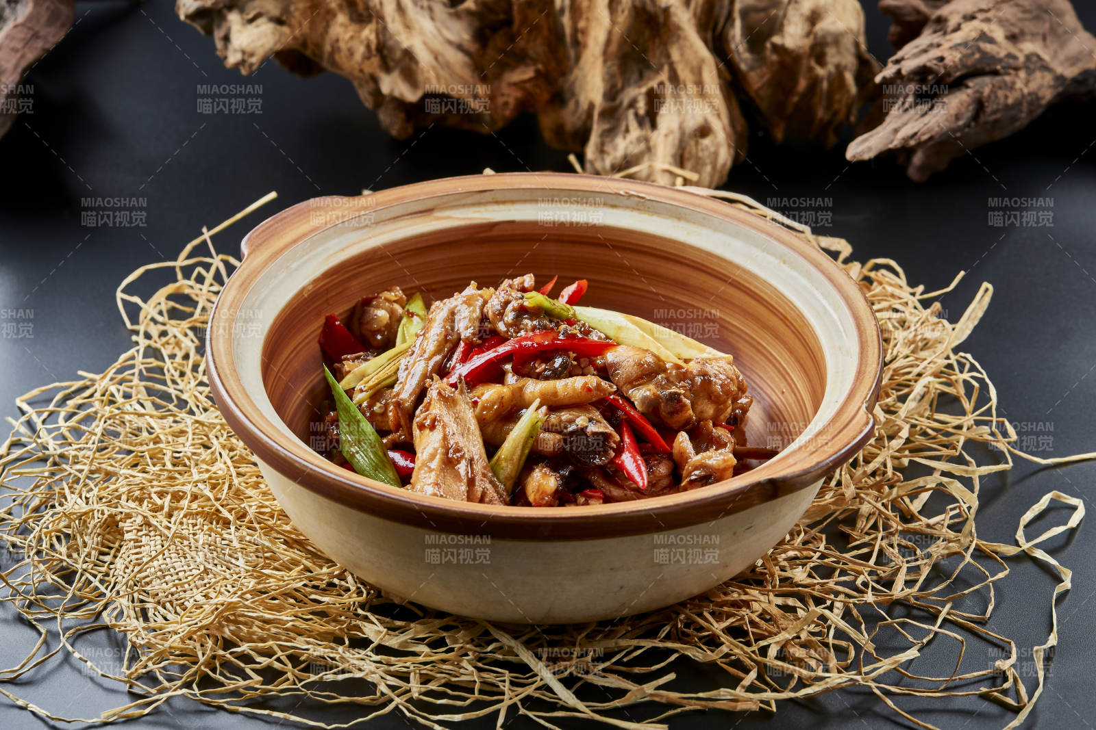 黑色背景上的砂鍋醬香雞塊煲