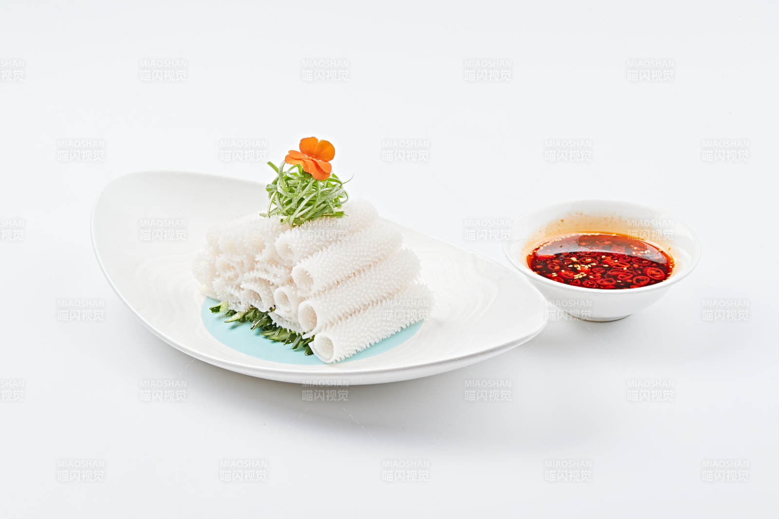 白色瓷盤裝的紅油墨魚卷