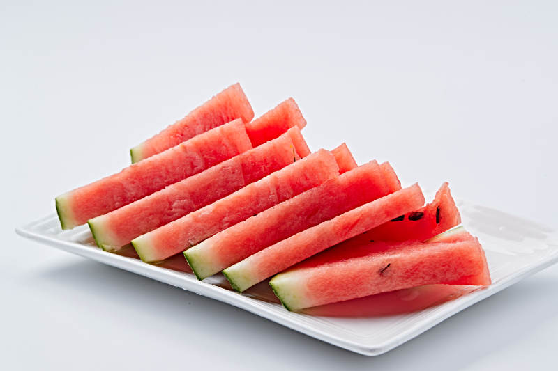 白色瓷盘装的切好的西瓜
