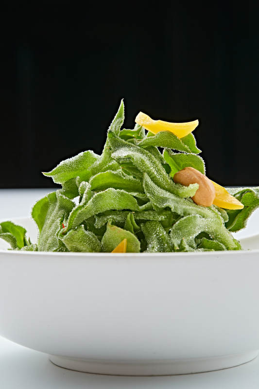 白色瓷盘装的麻酱凉拌穿心莲