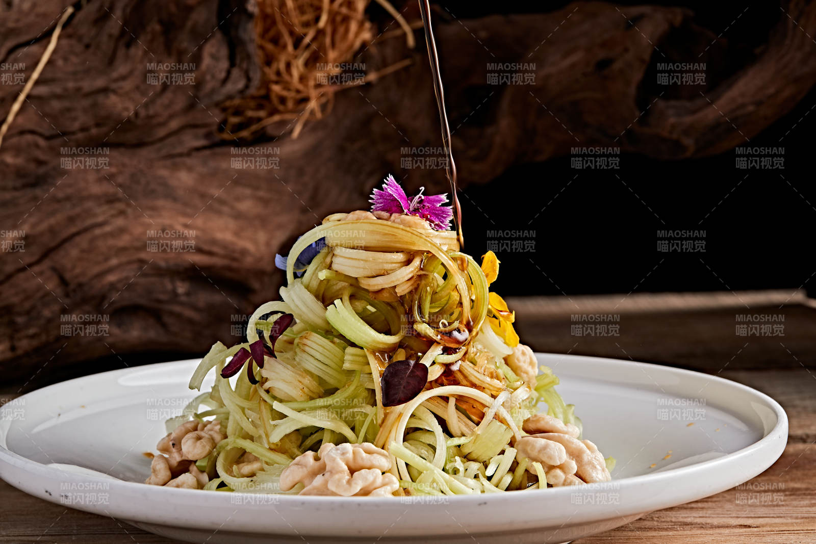 白色瓷盤裝的澆汁桃仁西芹絲