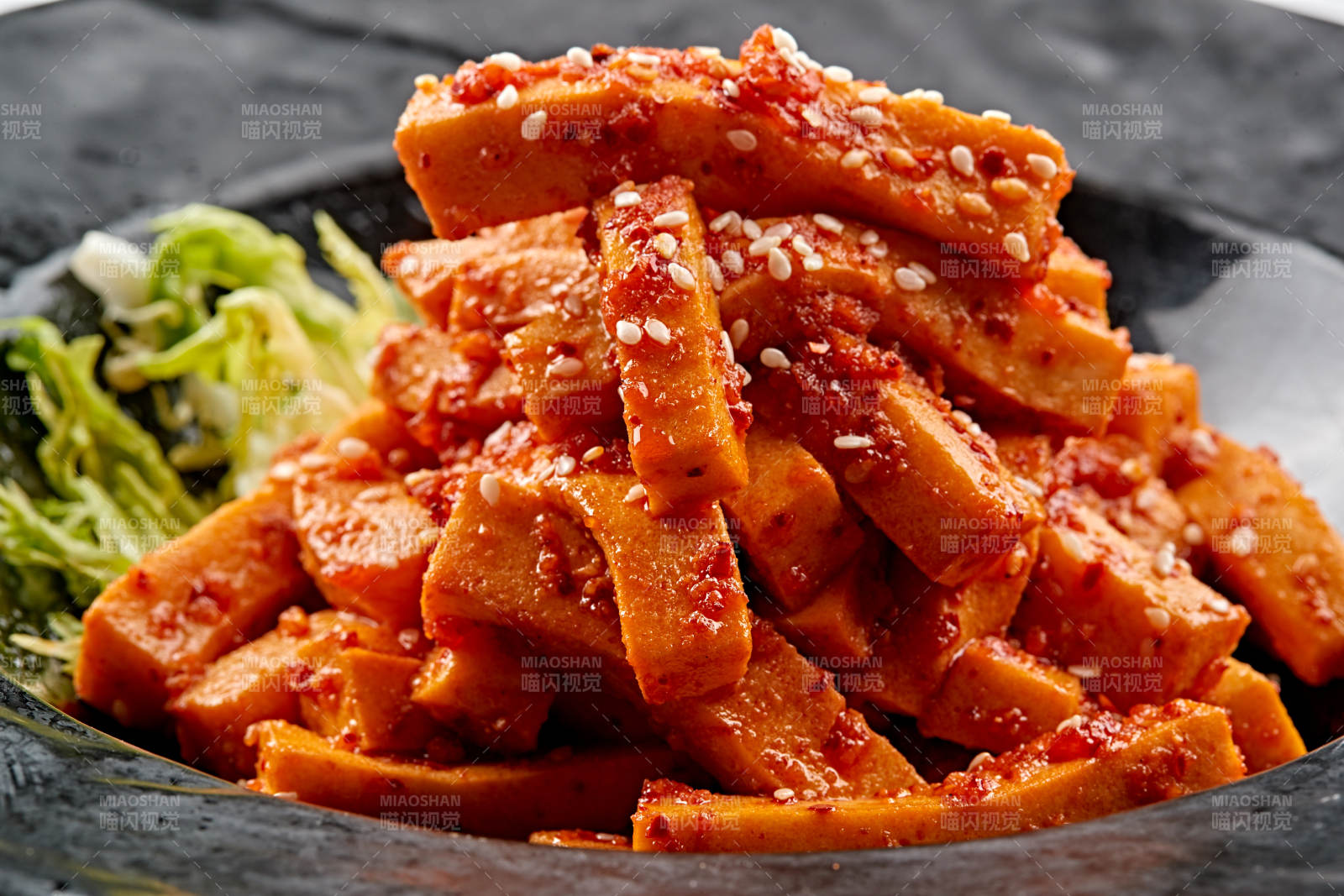 黑色餐具裝的秘制甜辣杏鮑菇