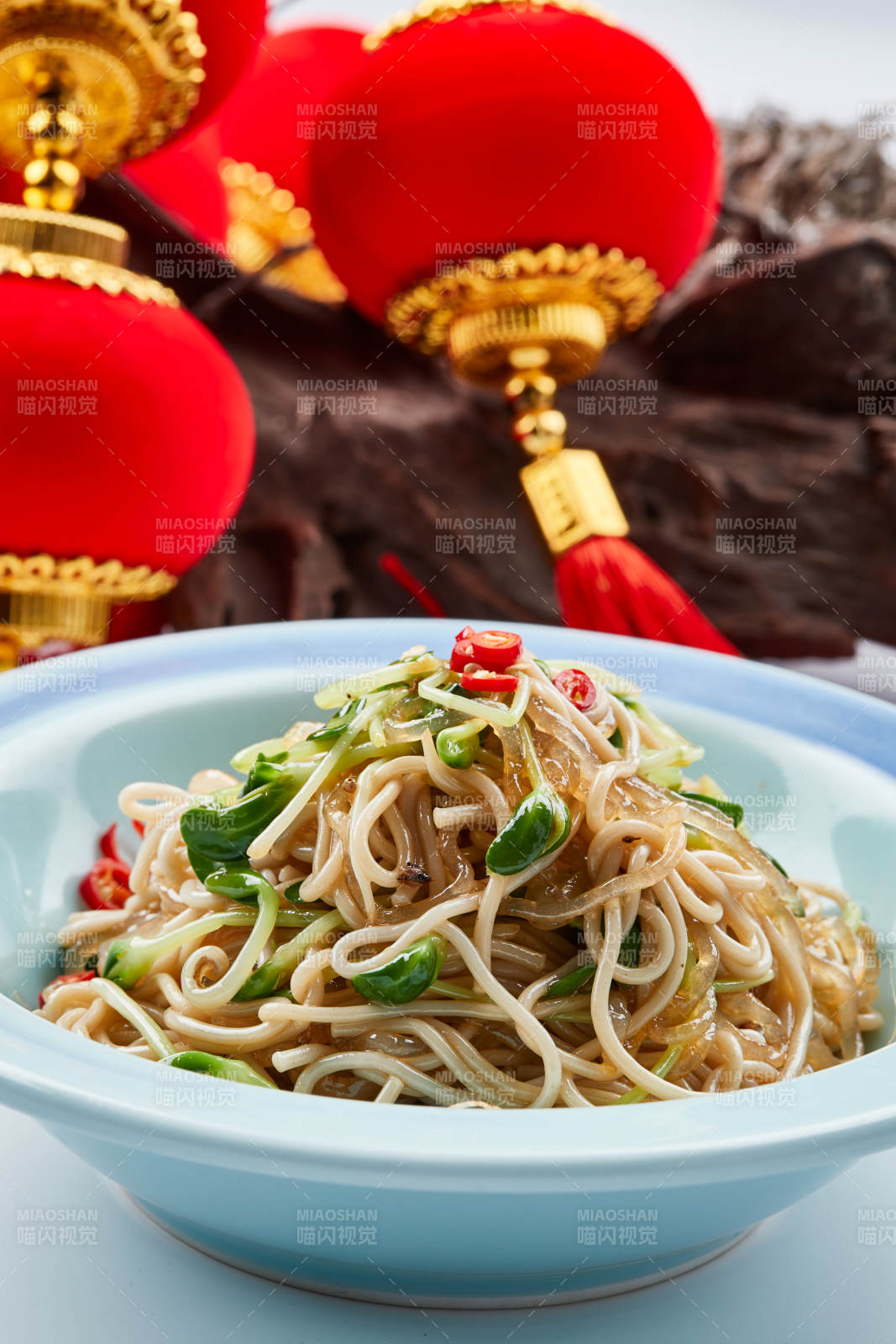青色瓷餐具裝的黑豆苗涼拌莜面饸饹