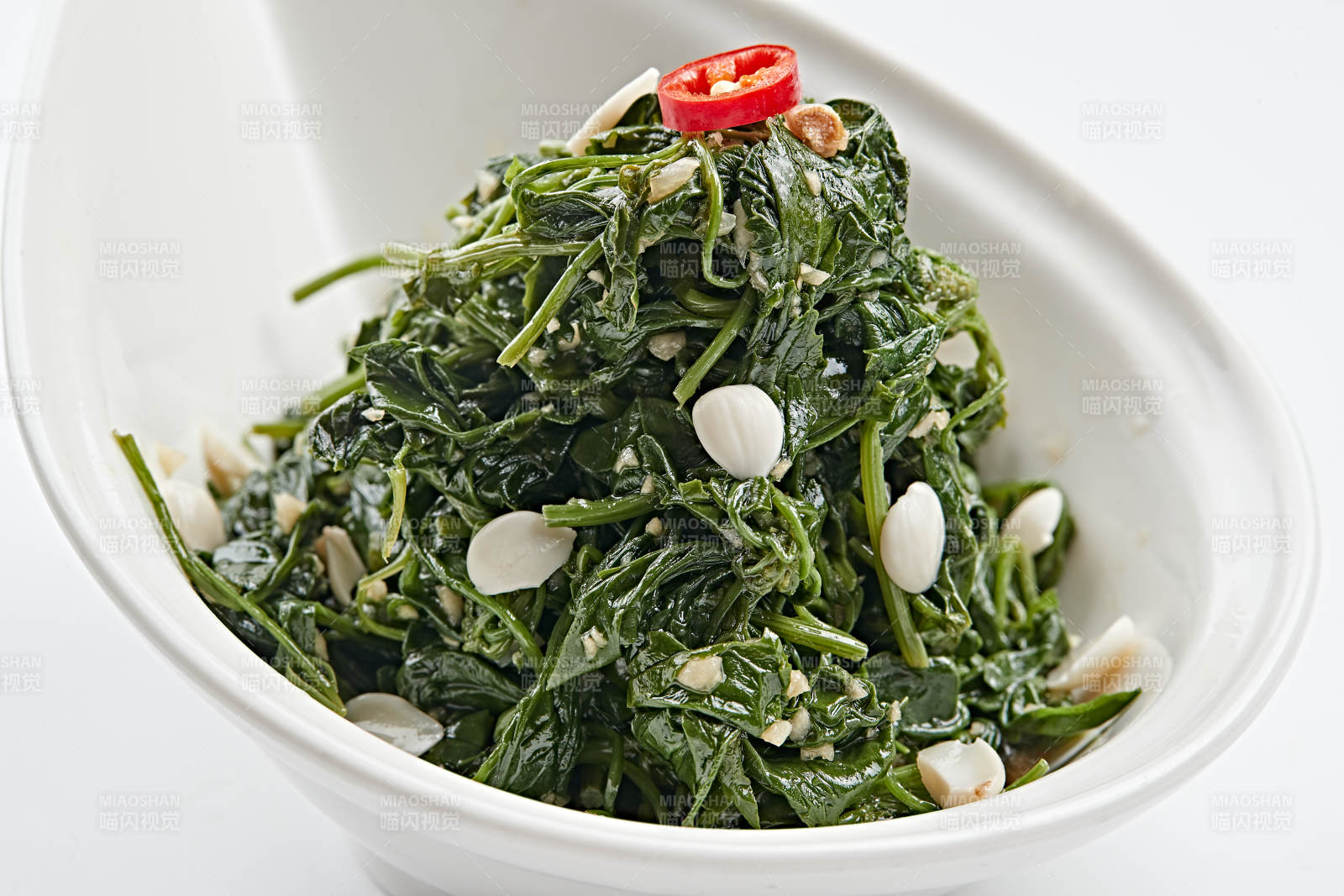 白色瓷盤裝的杏仁熗拌野菜