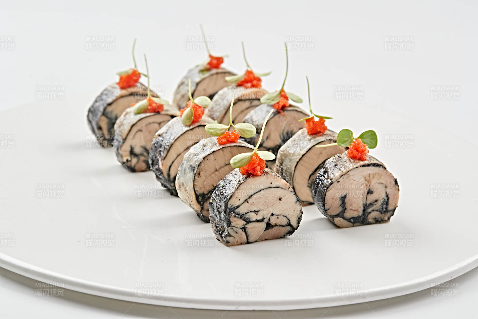 白色瓷盘装的压海苔金枪鱼卷切片