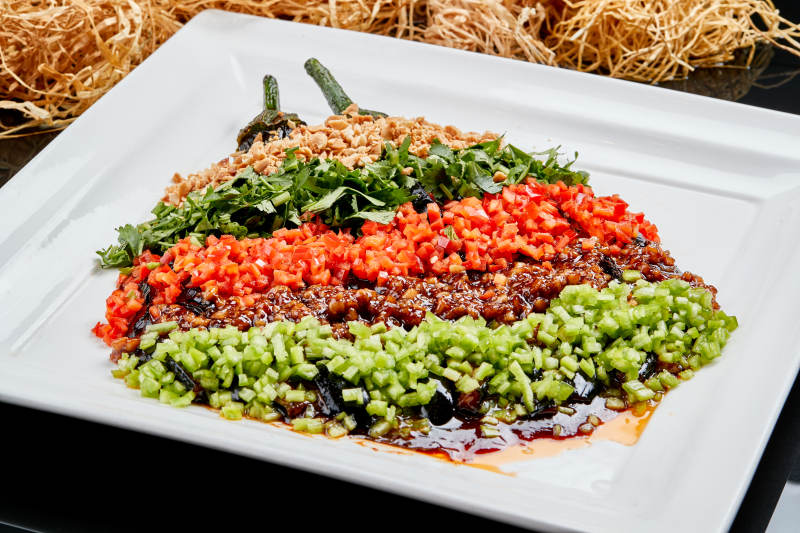 白色瓷盘装的酱香五色蒜泥茄子