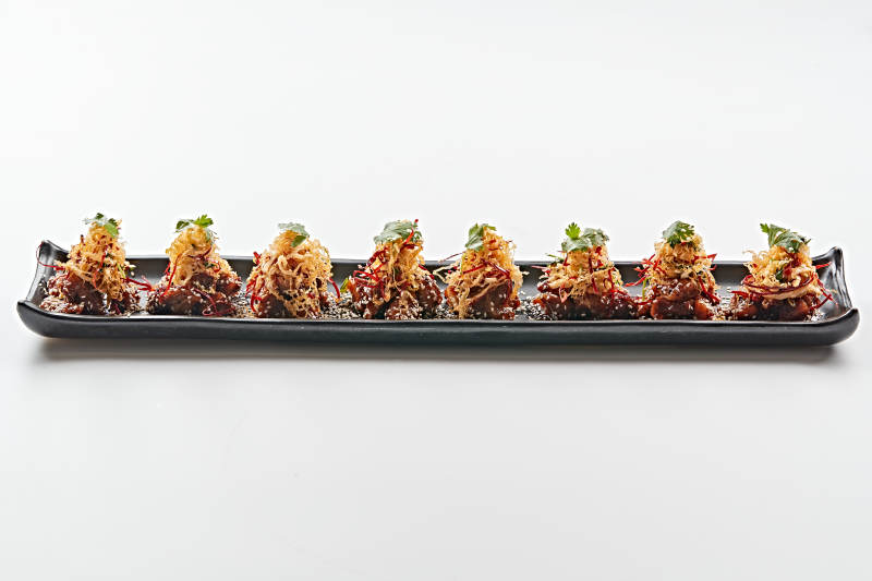 黑色长石盘装的油炸酸菜猪月牙骨