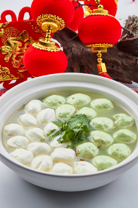 白色砂锅装的双色手打鱼丸