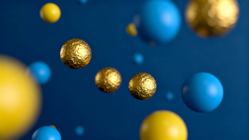 蓝色背景上的金色黄色球体漂浮-图片
