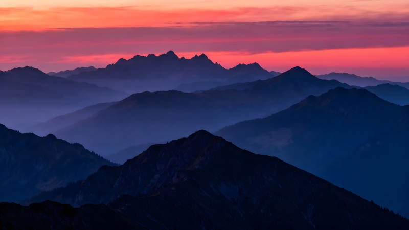山峦剪影下的绚丽晚霞图片