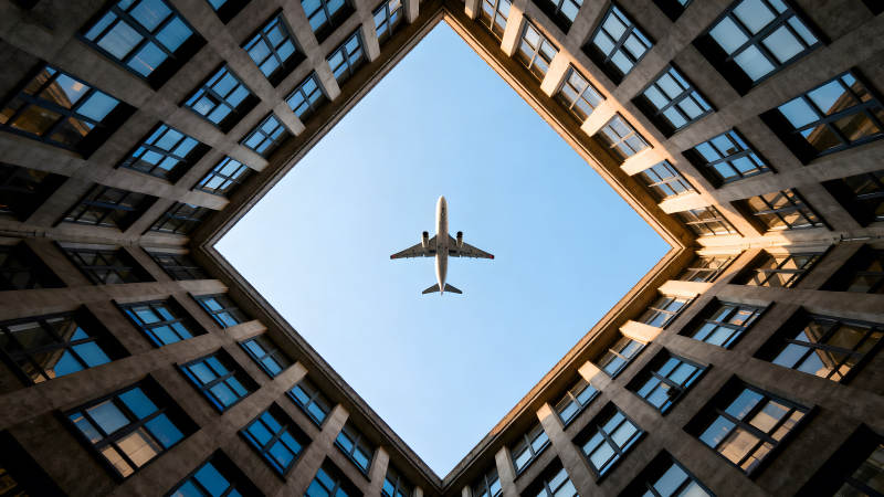 飛機穿梭樓宇天空俯瞰-圖片
