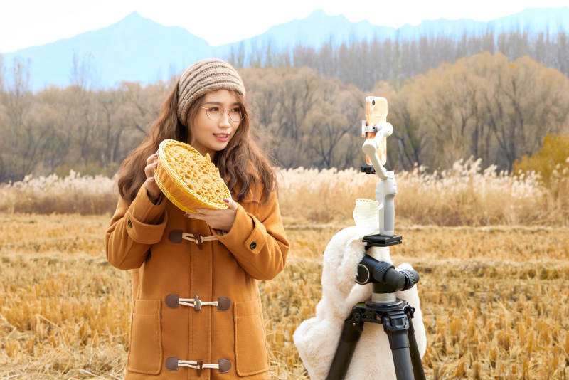 深秋季节在户外进行直播带货的亚洲女性图片