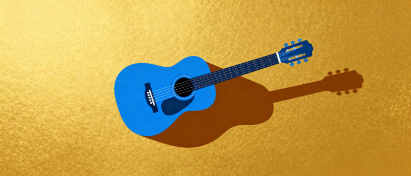 蓝色吉他静置金黄背景图片