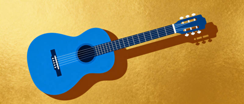 蓝色吉他静置金黄背景图片