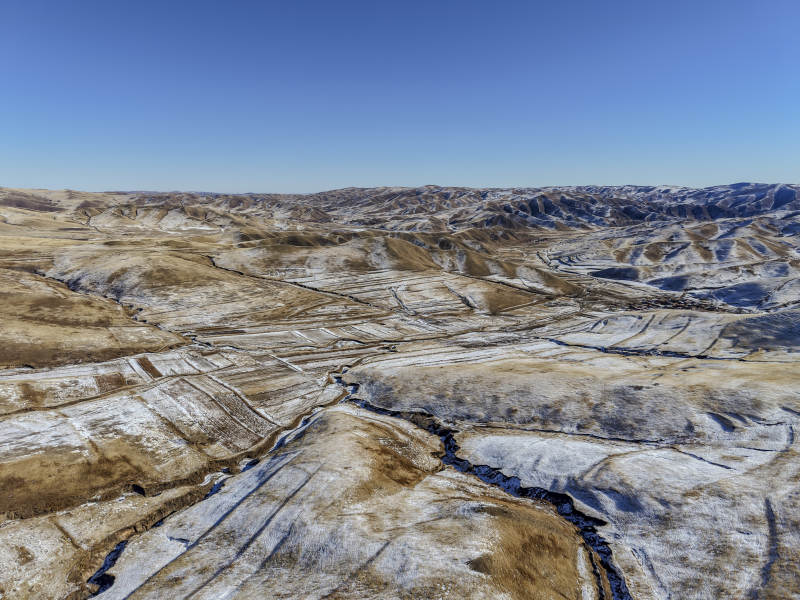 雪覆荒原 蜿蜒河流图片