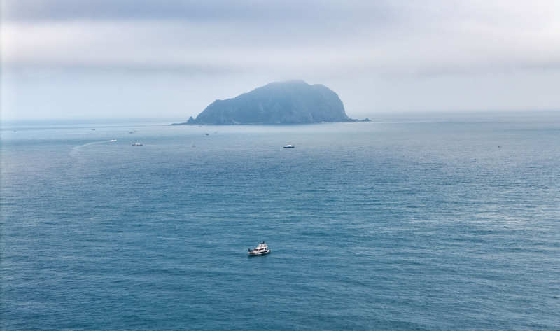 海天一色孤岛行舟图片