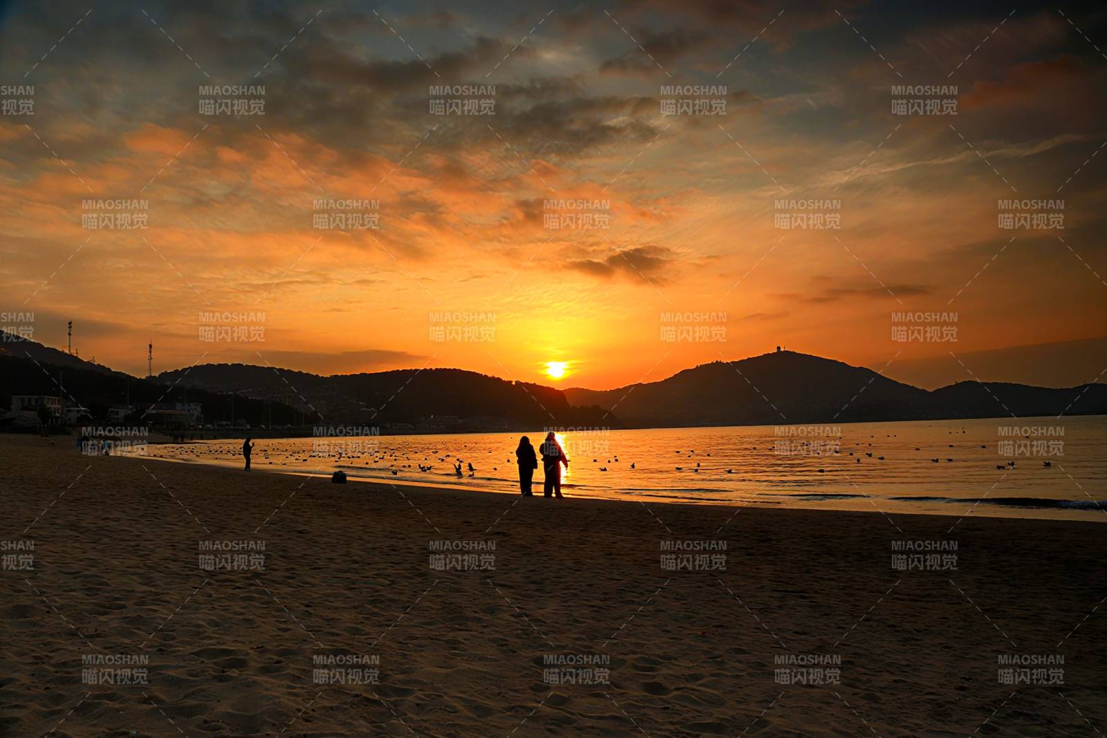 夕阳下的海滩剪影图片