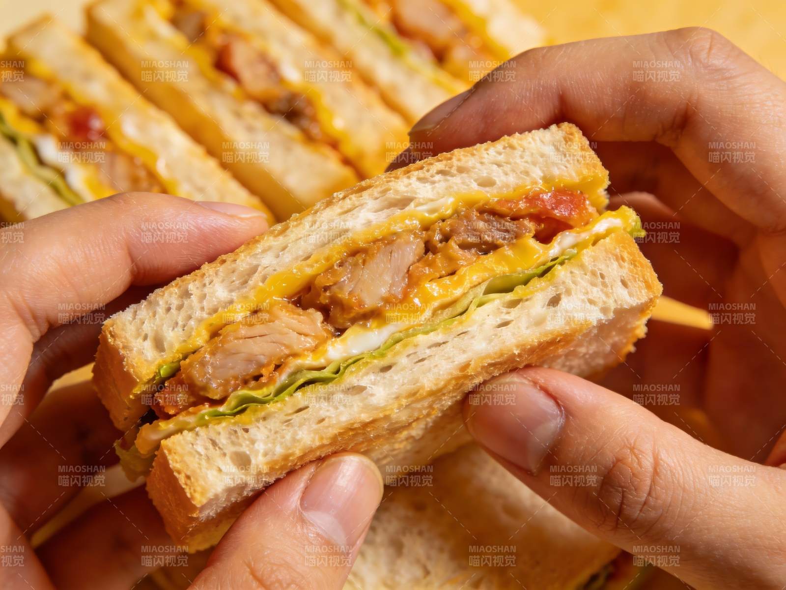 手握美味三明治特写图片