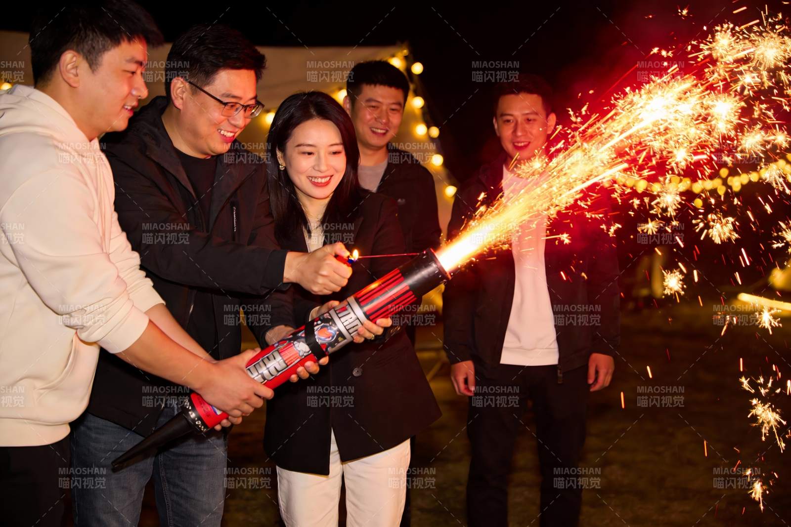 四人手持烟花棒夜间庆祝图片