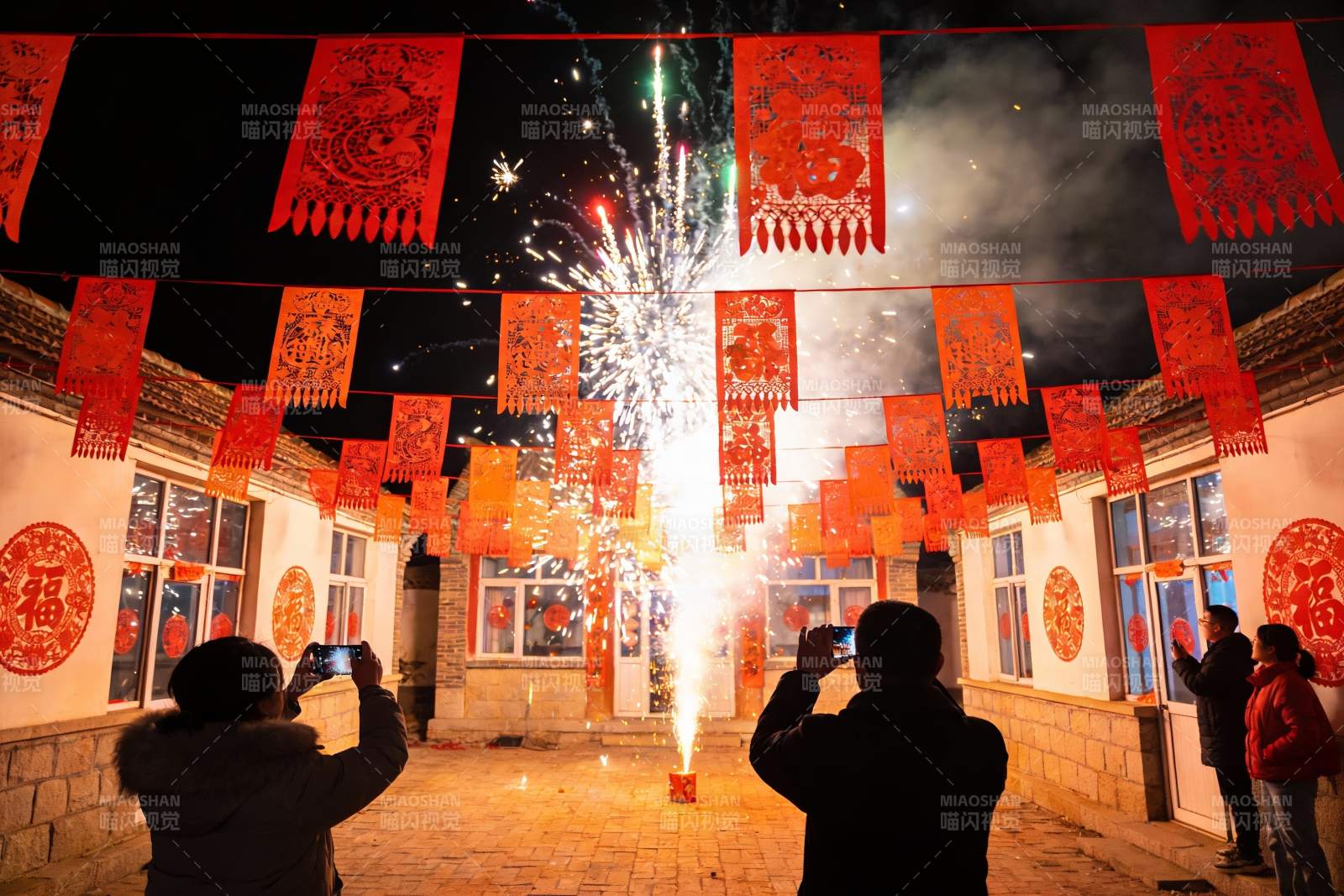 夜空中绽放的烟花与欢庆人群图片