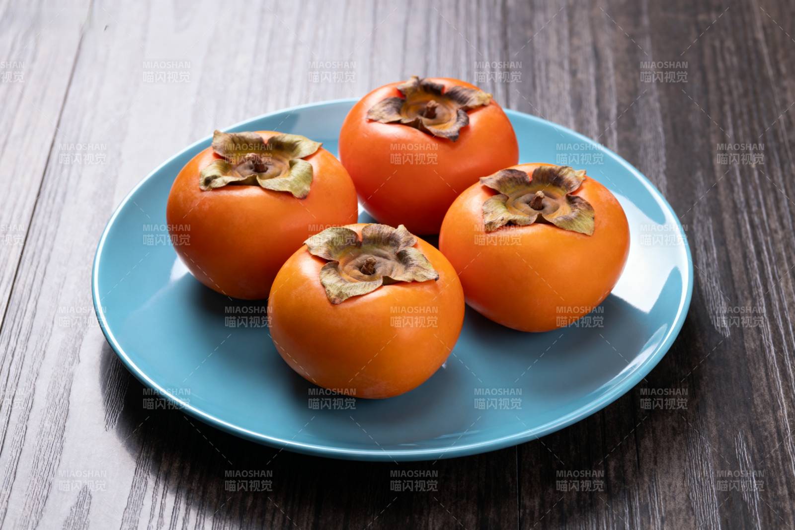 柿子四颗盘中摆图片
