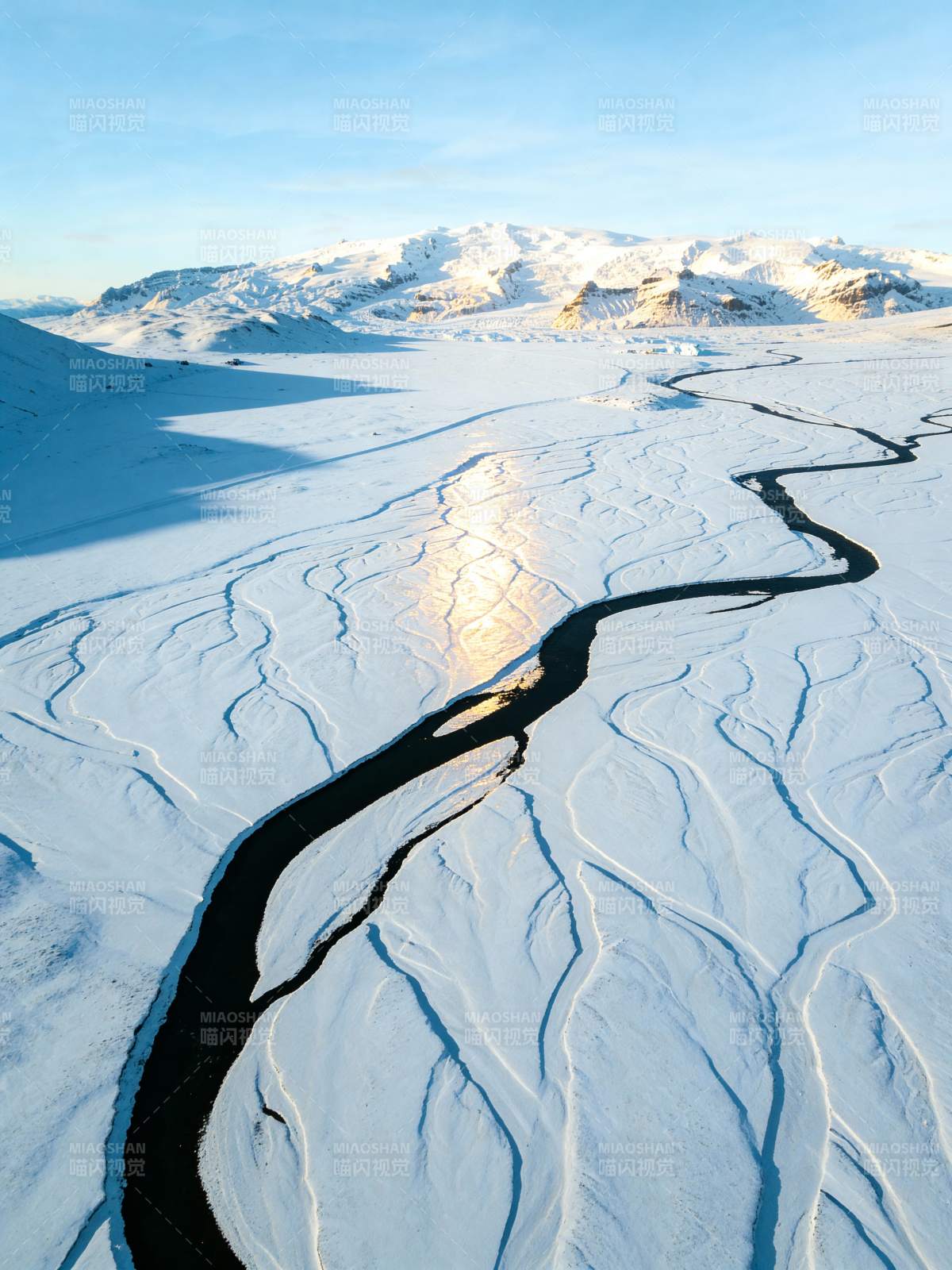雪原上的蜿蜒河流图片